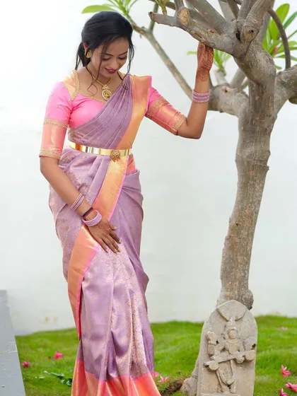 A full-length shot of the lavender and pink saree, showing its beautiful drape and color combination.