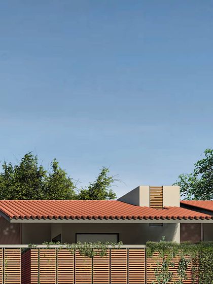 This view shows how the rooflines and boundary walls work together to form a unified architectural language. The design balances privacy for each home with a sense of an open, interconnected community street.