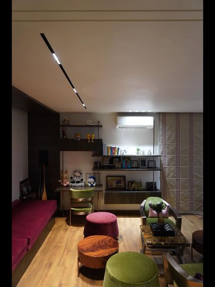 A cozy den in a completed project, featuring smart track lighting and an integrated audio system. We help create personalized spaces that are perfect for work, relaxation, or entertainment.