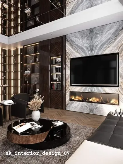 A close-up of the TV and fireplace unit, set against a dramatic marble wall. The mirrored ceiling reflects the entire space, adding to the sense of luxury and grandeur.