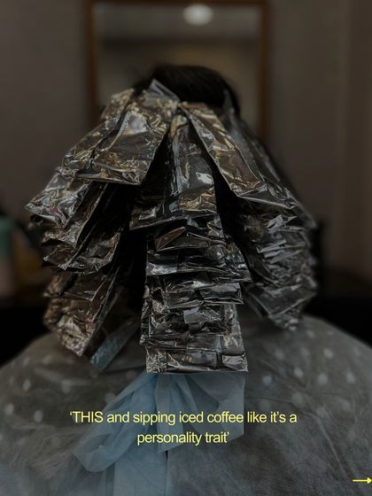 Sipping iced coffee like it's a personality trait while your color processes. It's all part of the salon experience.