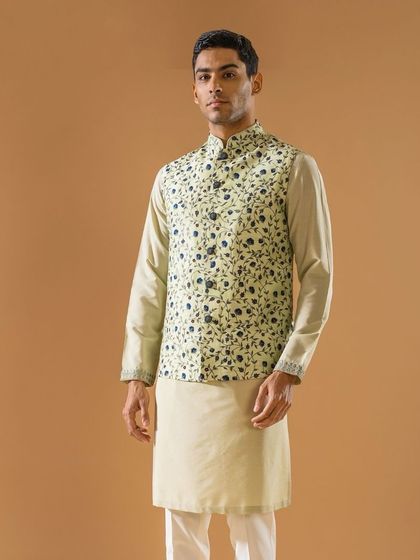 A pastel green Jawahar jacket with a delicate blue floral print. Paired with a neutral kurta, this ensemble casts a lasting impression with its subtle and refreshing color palette.