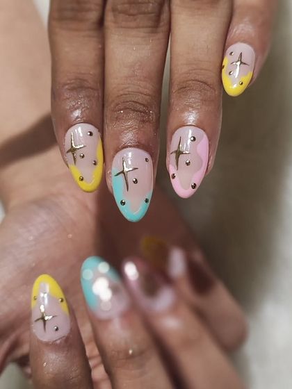 Another view of the pastel starry nails, showing how the colors and charms work together.