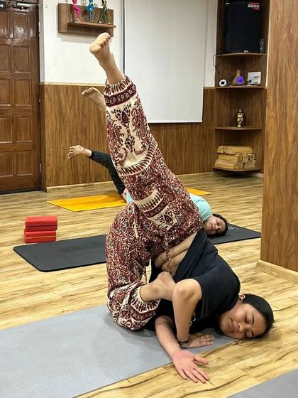 Even in a challenging pose, this student finds a sense of calm and ease. This is the goal of our practice: to find stillness even when the body is working hard.