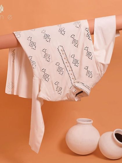 Our white kurta with geometric mirror work is a fresh and modern take on a classic. It's a light and breathable option for summer festivities.
