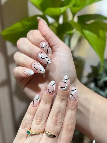 The clean, crisp lines of this hand-painted design show the precision and skill of our nail artists.