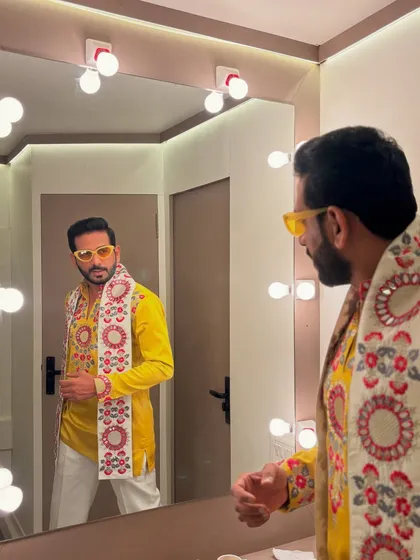 Getting ready for a big Garba night. This vibrant yellow kurta with a detailed, embroidered scarf and funky yellow glasses is all about festive energy.