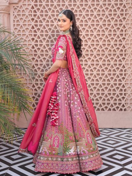 A back view of the bride's beautiful lehenga and hairstyle. The long, flowing waves add a touch of modern romance to her look.