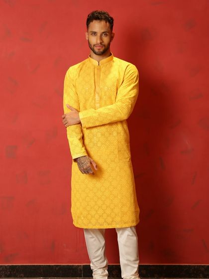 A full view of the yellow kurta, a must-have for the groom's friends to shine at the Haldi ceremony.