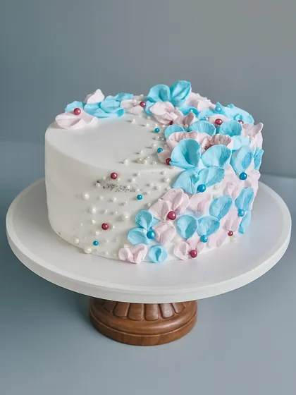 Welcoming a new life is such a special moment, and this baby shower cake was designed to capture that delicate joy. It's a classic Black Forest cake decorated with soft, hand-piped florals in pink and blue. It’s simple, sweet, and perfect for the occasion.