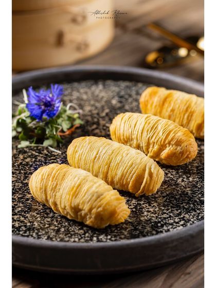 Crispy fried spring rolls with a delicate, thread-like texture, shot for Shang Palace.