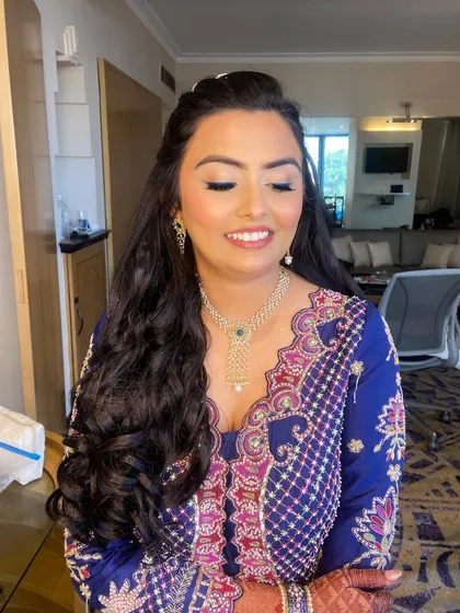 A close-up of Bansi's mehendi makeup, showing the subtle blue wing and glowing skin.