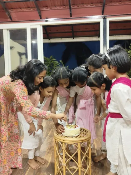 Sāttvatī is a family, and we celebrate every milestone together. Here I am with my youngest students, my kids, sharing a happy moment and cutting a cake to celebrate our school's anniversary.