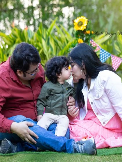 A tender family moment on the grass, where the mother gives her toddler a gentle kiss. These are the quiet, love-filled memories I aim to preserve.