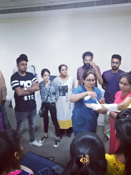A doctor demonstrates the correct technique for applying a bandage during our first aid training.