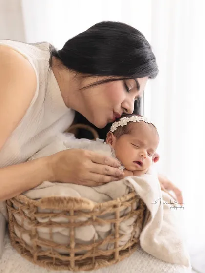 A soft kiss for her sleeping baby. These are the quiet, intimate moments that I strive to capture, preserving the tenderness of early motherhood.