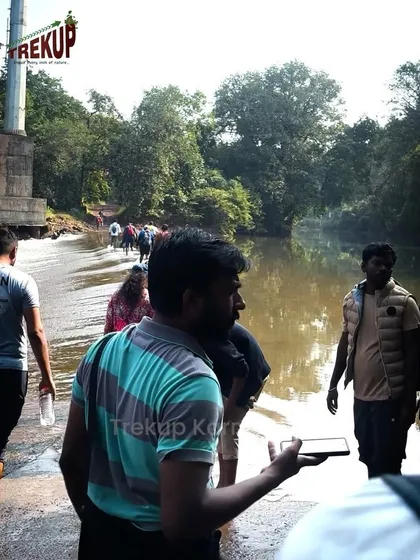 Our group carefully crossing a river during the Dudhsagar trek. Our guides are always there to ensure safety.