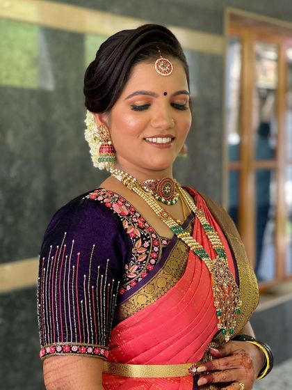 The makeup is soft and glowing, designed to enhance her features and last throughout the day's events.