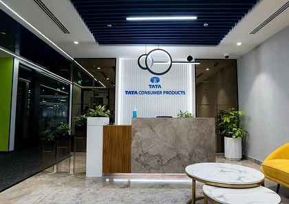 The reception area for Tata Consumer Products. The design is clean and modern, with carefully placed plants that add a touch of nature without cluttering the space, reflecting a brand that values clarity and quality.