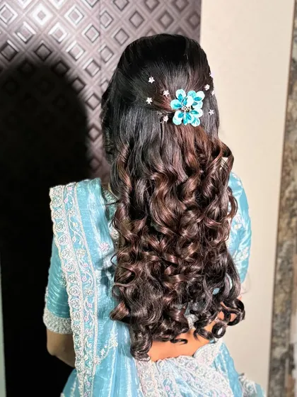 The details of the engagement hairstyle, showing the placement of the accessory and the texture of the curls.
