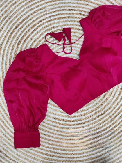 The organza balloon sleeve blouse in a vibrant rani pink.