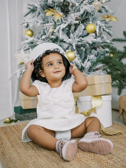 A little girl playing with a gift box during her Christmas mini-session. The best moments are often the unscripted ones.