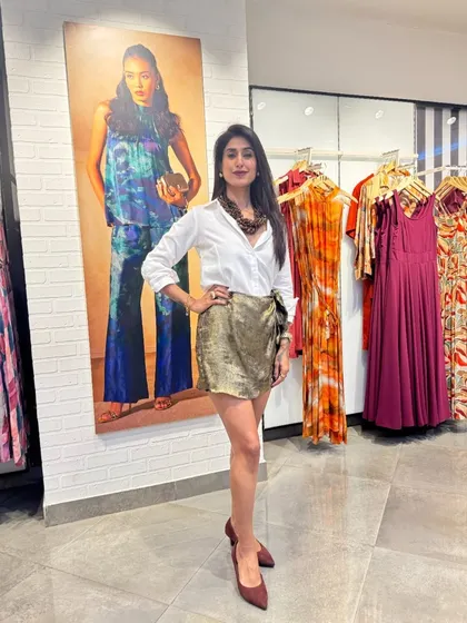 Dressing is an art form. Here, I've paired a classic white shirt with a sequined skirt and statement necklace, showing how you can mix basics with bold pieces to create a look that is uniquely yours.