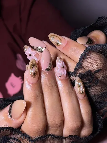 Nails for the bride's sister. This design features a soft pink base with 3D pink flowers, gold leaf accents, and pearl details.