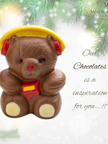 A modern twist on a classic, this milk chocolate teddy bear is ready to rock with detailed yellow headphones and a small red crystal emblem.