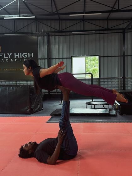 The "bird" pose in acro yoga is a foundational move that builds trust and stability between partners.