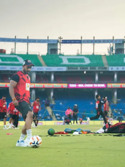 Setting up for a drill on the field. The stadium background highlights the professional environment we train in.