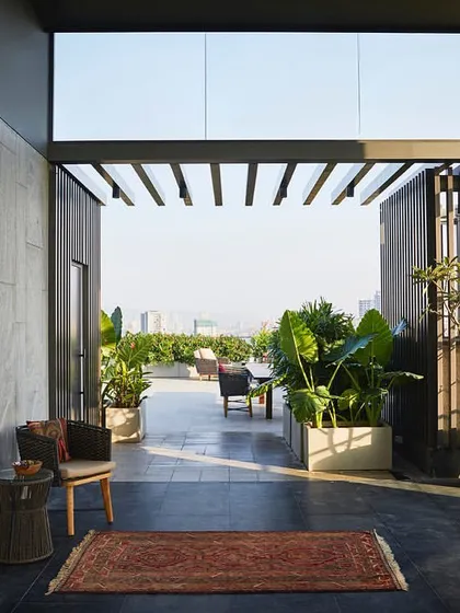 The entrance to the terrace features a Brinda Miller 'Cartpet' artwork, adding a unique design element to the transition space between the indoor lobby and the open-air deck.