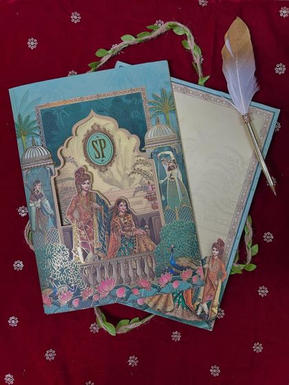 A beautiful example of a heritage-inspired design, featuring a custom monogram and pop-up illustrations of a royal couple and peacocks.