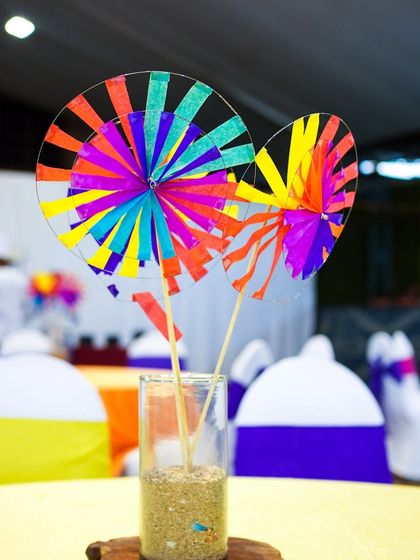 A colorful pinwheel centerpiece adds a simple yet festive touch to the guest tables.