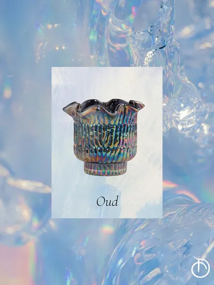 The deep, complex scent of Oud is captured here in a dark, iridescent Zen Lotus votive, offering a moment of grounding and calm amidst the energy of summer.