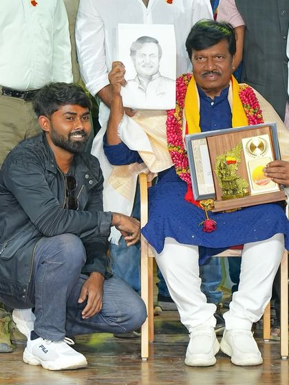 A proud moment presenting a live sketch to actor and director T.S. Nagabharana on stage.