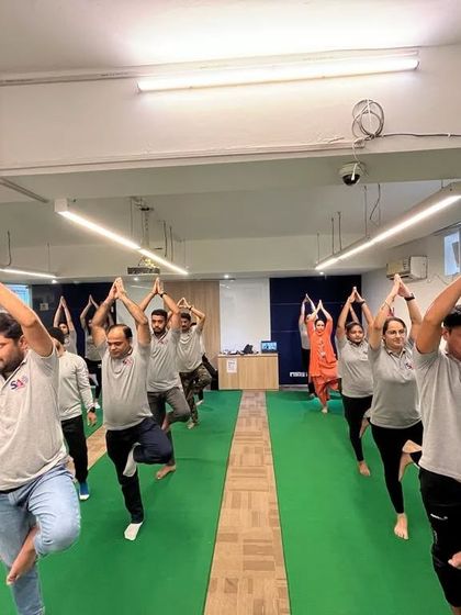 The team at SA Consultant practicing Vrikshasana (Tree Pose) together, finding their balance.