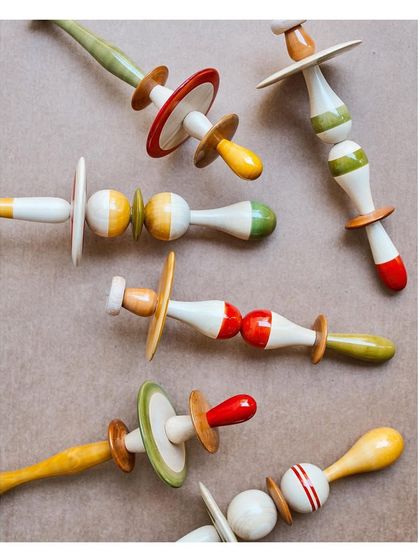 A closer look at the vibrant, natural colors of the Channapatna craft. The red comes from the Manjista root, yellow from turmeric, and green from indigo, showcasing the beauty of organic materials.