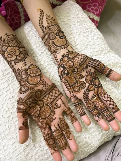 An intricate design that blends traditional density with modern floral elements. The pattern covers the hands completely but maintains a sense of flow and movement.