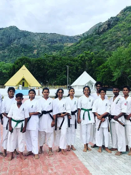 A group of our black and green belt students during a special Black Belt Camp, set against a beautiful natural backdrop.
