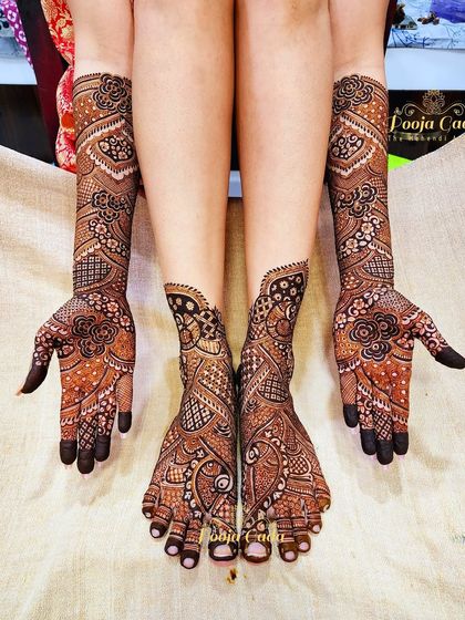 A complete traditional bridal mehendi set, with intricate floral and jaal patterns covering both hands and feet for a cohesive and stunning look.