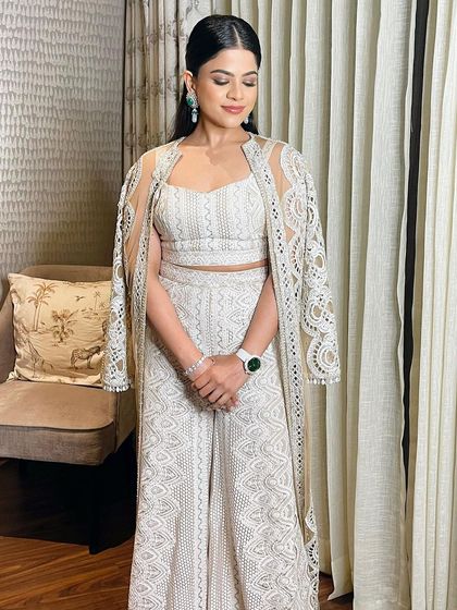 The full look, where the client looks effortlessly chic and polished. The makeup enhances her natural beauty and complements her elegant outfit perfectly.