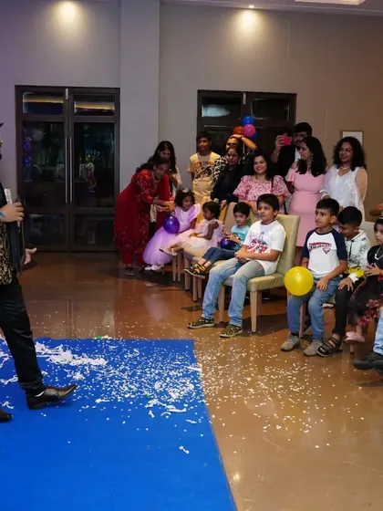 A shot of the audience, filled with kids and adults, enjoying the show. My family-friendly magic is designed to entertain guests of all ages together.
