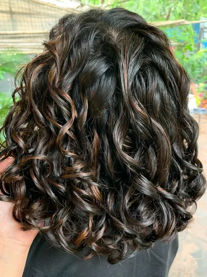 A close-up of the curls on this bridal bob. The color is subtle, elegant, and perfect for her wedding day.