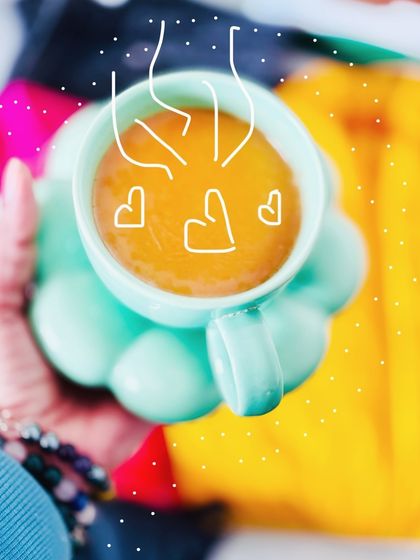 A cute, creative shot of a cup of chai with doodle hearts, part of the weekend flatlay series.