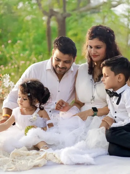 A complete family, all dressed in white, enjoying a moment together in the soft sunlight. We love creating these natural light family portraits that feel dreamy and real. These are the frames that will hang on your walls for years.