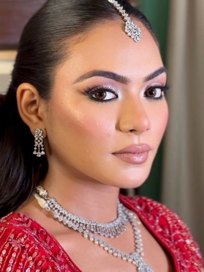 A close-up of Komal's flawless engagement makeup. The winged liner is sharp, the skin is radiant, and the lip colour is the perfect nude.