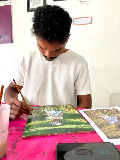 A student paints on a wooden board, one of the different surfaces we explore in our acrylics course. This helps you understand how the medium behaves on various materials.