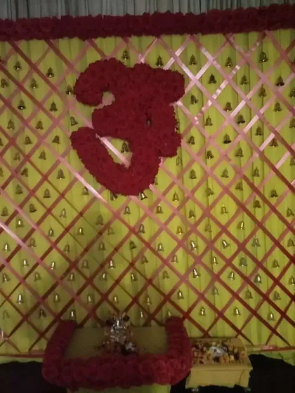 A sacred Om symbol made entirely of red roses. I designed this as a centerpiece for a backdrop, creating a powerful focal point for meditation and prayer during a home pooja.
