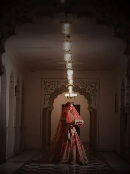 A bridal portrait that feels like a painting. Using dramatic lighting and the stunning architecture of palace corridors, we craft artistic and moody shots that showcase the bride's elegance in a truly cinematic way.